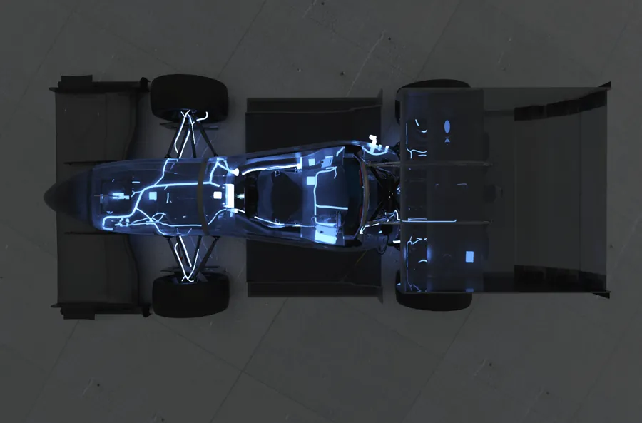Glowing blueprint view of a race car chassis